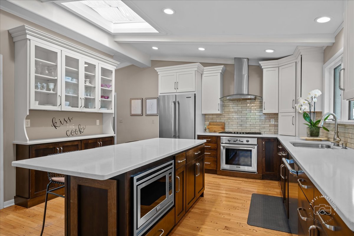 705 Meadows Road Geneva, IL 60134 - Photo 5 of 27 a kitchen with a stove a sink and a refrigerator
