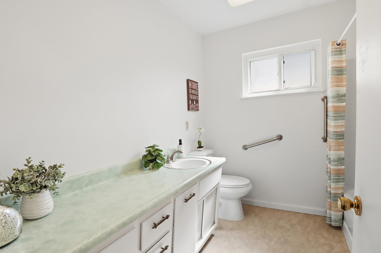 3366 Point Pleasant Road Elk Grove, CA 95757 - Photo 34 of 60 a bathroom with a sink mirror and a toilet