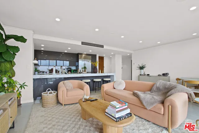 a living room with furniture and kitchen view