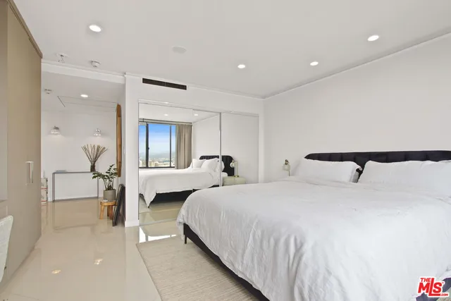 a bedroom with bed and window