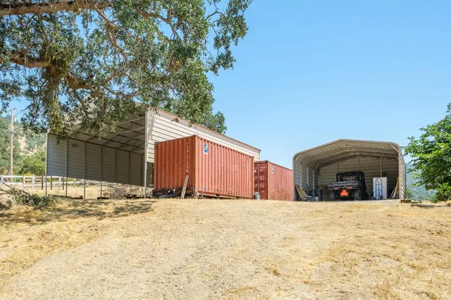 a backyard of a house with yard and outdoor seating