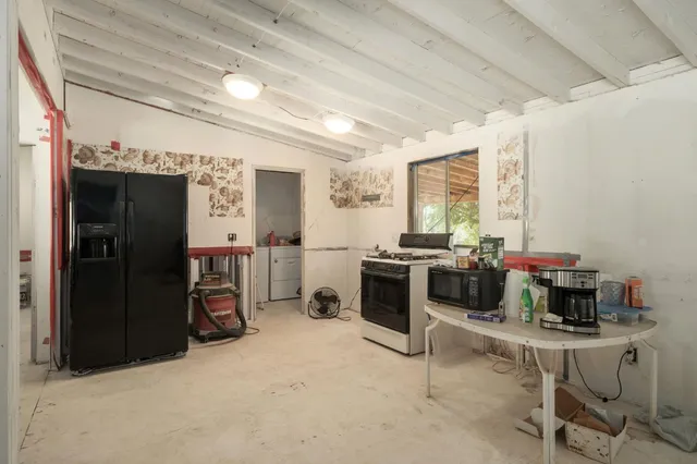 a view of a two room with furniture