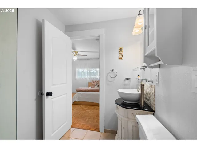 a bathroom with a tub sink and mirror