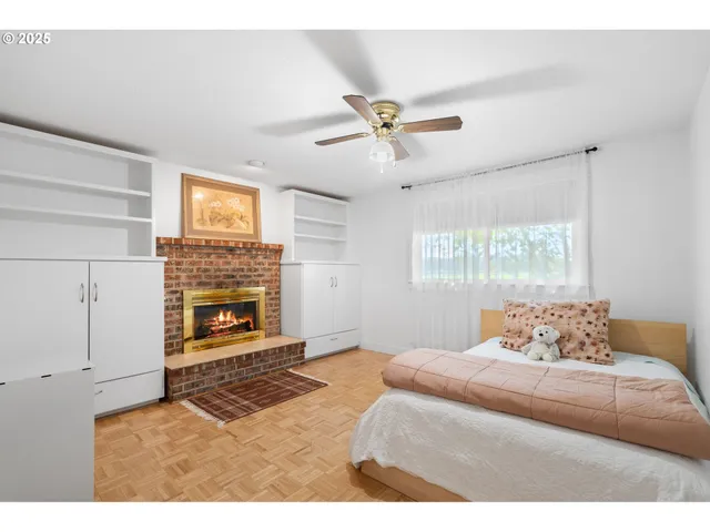 a bedroom with a bed and a fireplace