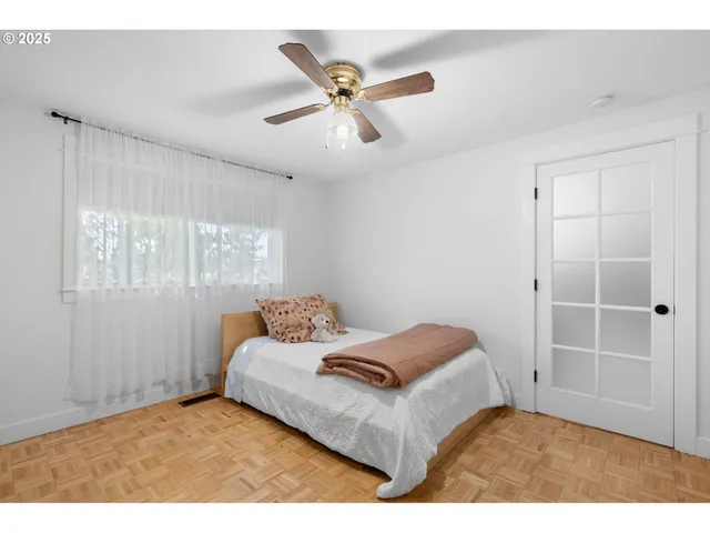 a bedroom with a bed and a window