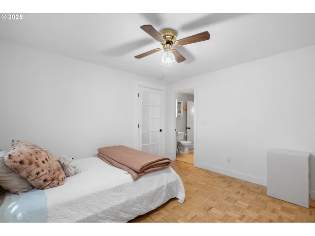 a bedroom with a bed and a ceiling fan
