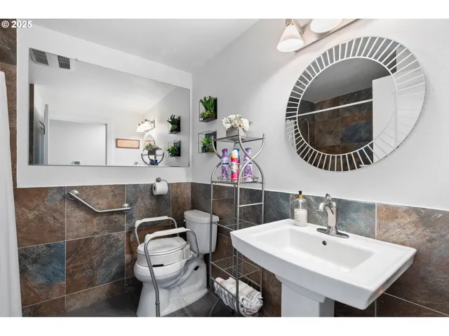 a bathroom with a toilet a sink and mirror