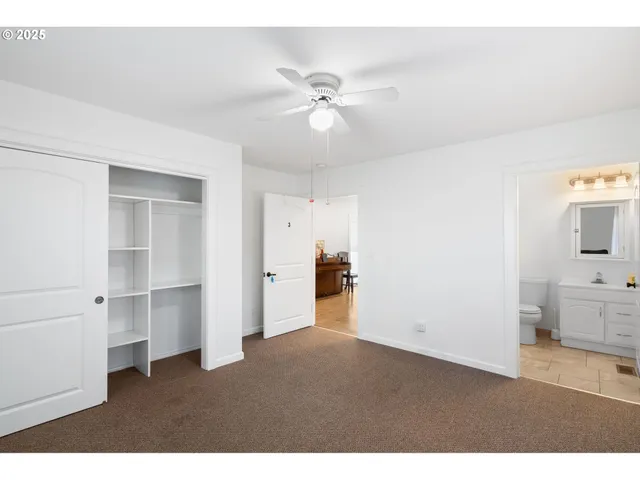 a view of empty room with cabinet and ceiling fan