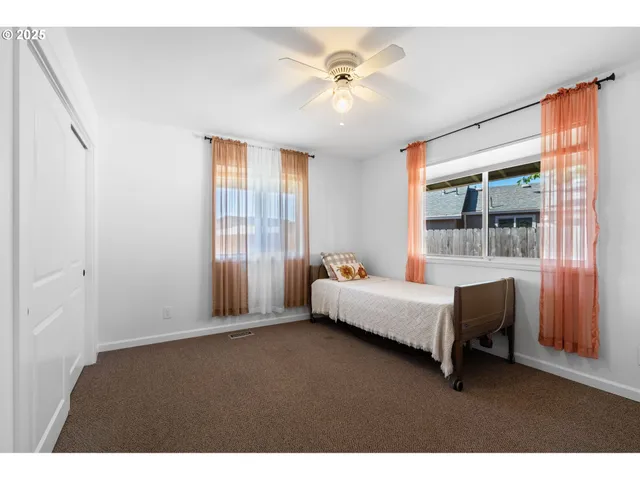 a bed room with a bed and a window