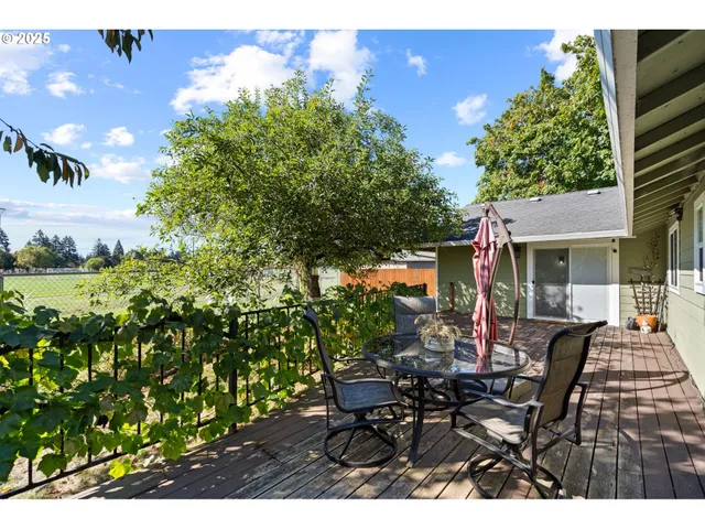 a view of a house with backyard and sitting area