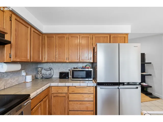 a kitchen with stainless steel appliances a refrigerator sink and cabinets