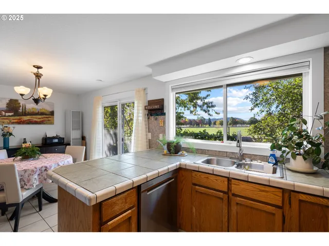 a kitchen with a sink and large window