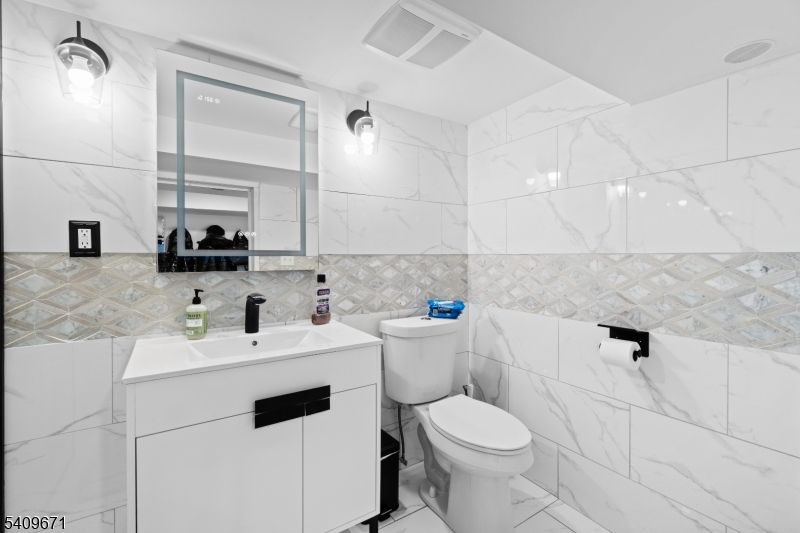 33 Mapes Avenue, Unit 2 Newark, NJ 07112 - Photo 14 of 40 a bathroom with a sink toilet and mirror