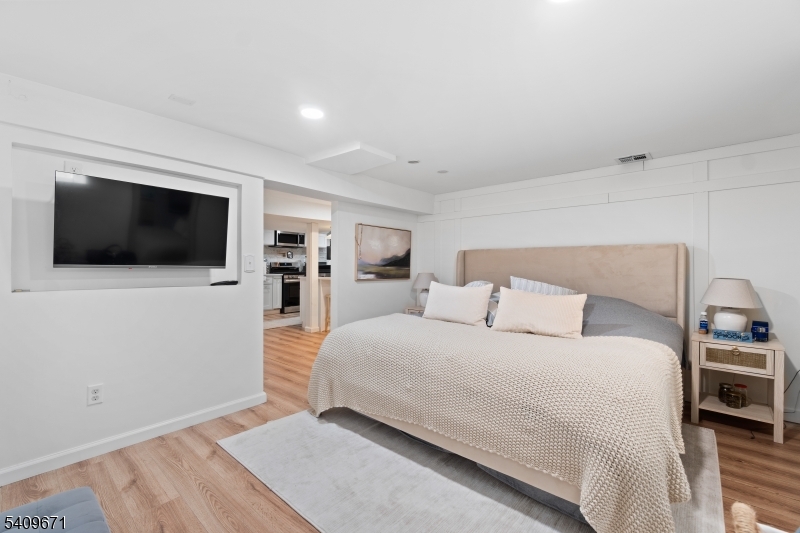 33 Mapes Avenue, Unit 2 Newark, NJ 07112 - Photo 19 of 40 a bedroom with a bed and a flat screen tv