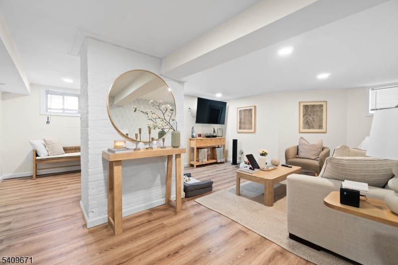 33 Mapes Avenue, Unit 2 Newark, NJ 07112 - Photo 20 of 40 a living room with furniture and a wooden floor