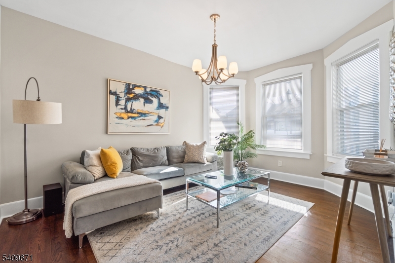 33 Mapes Avenue, Unit 2 Newark, NJ 07112 - Photo 2 of 40 a living room with furniture and a chandelier