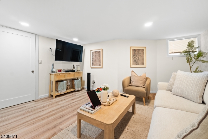 33 Mapes Avenue, Unit 2 Newark, NJ 07112 - Photo 21 of 40 a living room with furniture and a flat screen tv