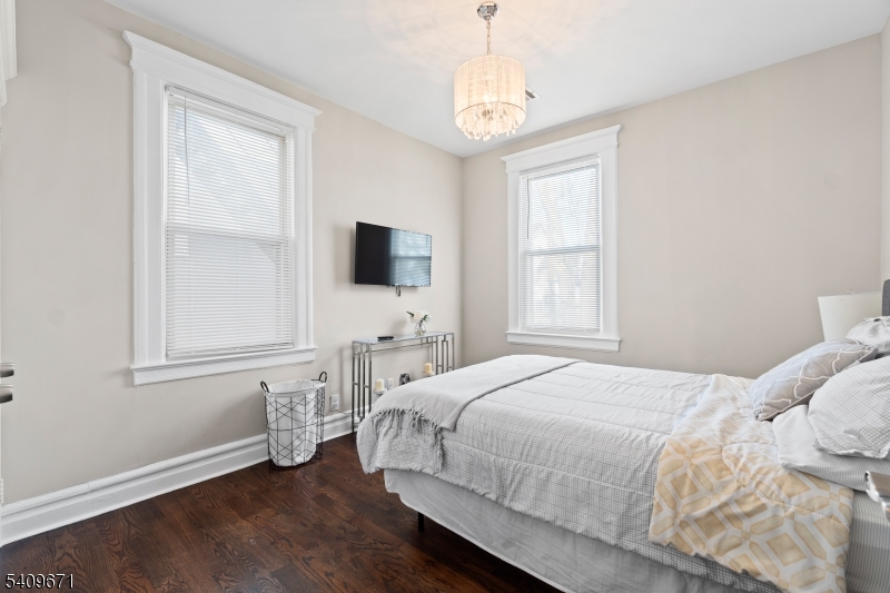 33 Mapes Avenue, Unit 2 Newark, NJ 07112 - Photo 26 of 40 a bedroom with a bed window and a flat screen tv