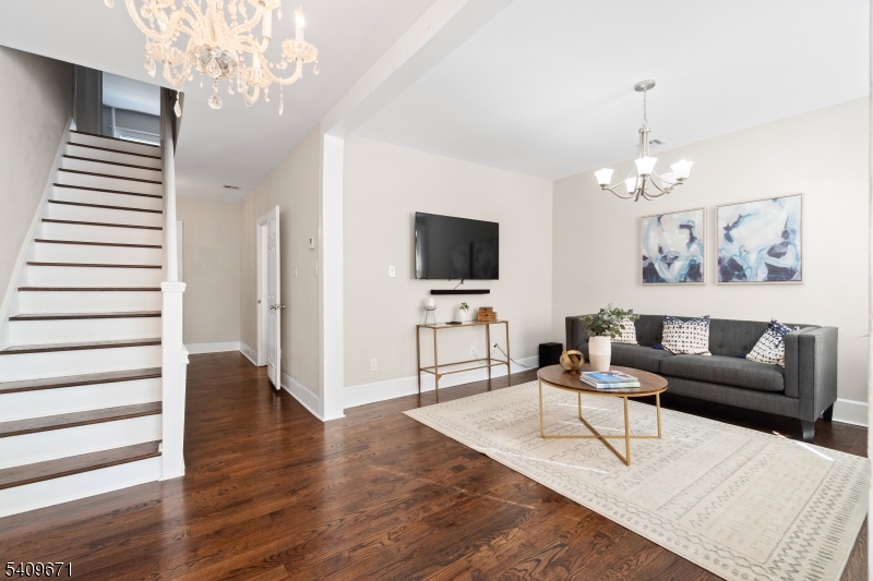33 Mapes Avenue, Unit 2 Newark, NJ 07112 - Photo 28 of 40 a living room with furniture a chandelier and wooden floor
