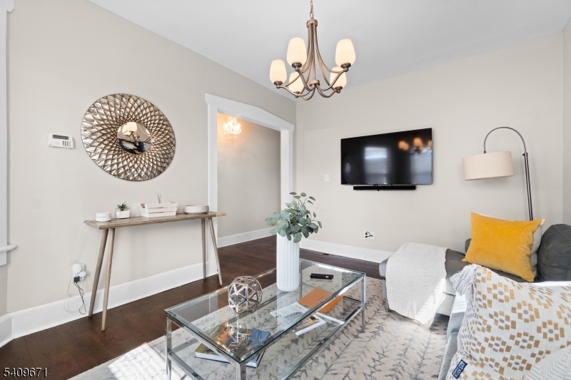 33 Mapes Avenue, Unit 2 Newark, NJ 07112 - Photo 3 of 40 a living room with furniture a flat screen tv and kitchen view