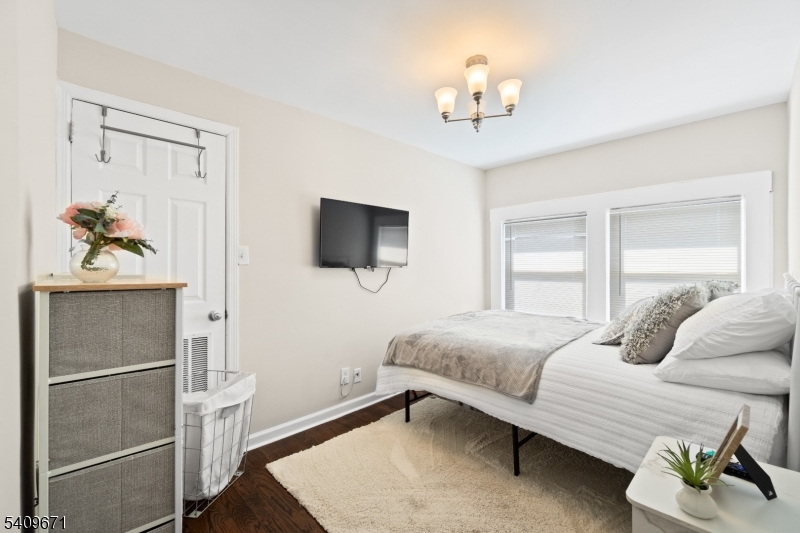 33 Mapes Avenue, Unit 2 Newark, NJ 07112 - Photo 33 of 40 a bedroom with a bed and a chandelier