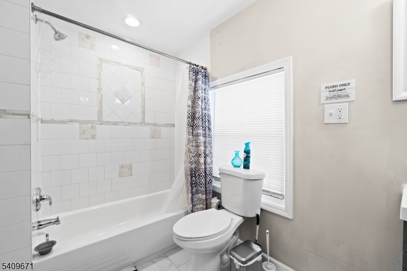 33 Mapes Avenue, Unit 2 Newark, NJ 07112 - Photo 35 of 40 a bathroom with a toilet a sink and a bathtub