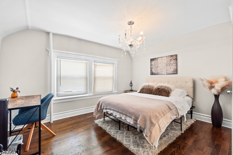 33 Mapes Avenue, Unit 2 Newark, NJ 07112 - Photo 39 of 40 a bedroom with a bed and a table in it