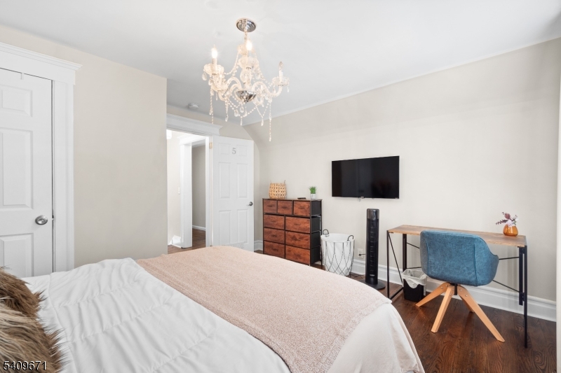 33 Mapes Avenue, Unit 2 Newark, NJ 07112 - Photo 40 of 40 a bedroom with a bed and a flat screen tv