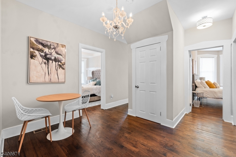 33 Mapes Avenue, Unit 2 Newark, NJ 07112 - Photo 5 of 40 a dining room with chandelier and wooden floor