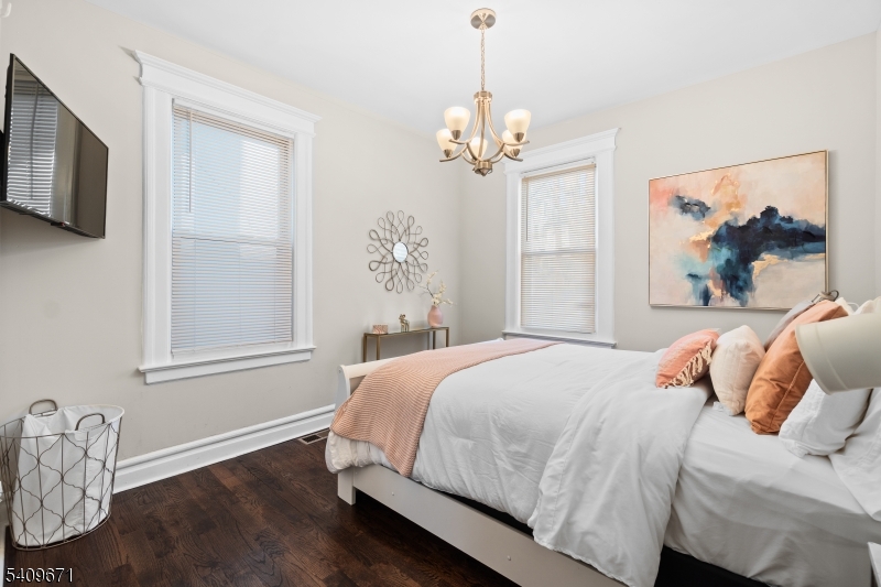33 Mapes Avenue, Unit 2 Newark, NJ 07112 - Photo 7 of 40 a bedroom with a bed chandelier and window