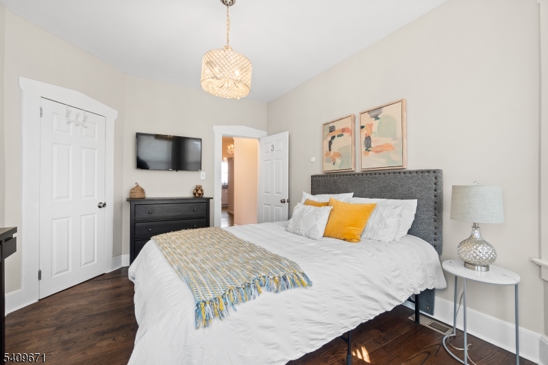 33 Mapes Avenue, Unit 2 Newark, NJ 07112 - Photo 9 of 40 a bedroom with a bed and a flat screen tv