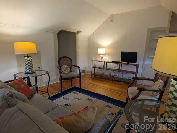 a living room with furniture and a lamp