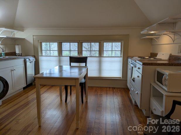 220 Melrose Circle, Unit 2 Tryon, NC 28782 - Photo 3 of 10 a kitchen with stainless steel appliances granite countertop a stove top oven a sink dishwasher and cabinets with wooden floor