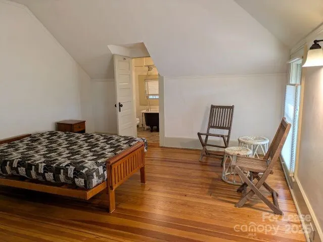 a bedroom with a bed and a chair