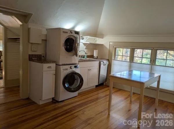 a view of a hallway with washer and dryer