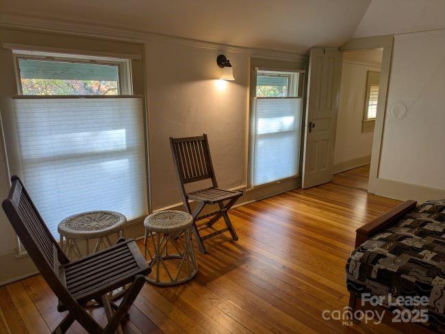 220 Melrose Circle, Unit 2 Tryon, NC 28782 - Photo 5 of 9 a view of a room with wooden floor and chair