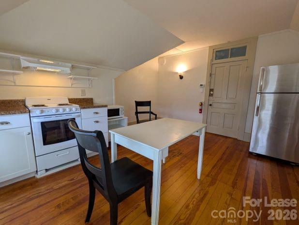 220 Melrose Circle, Unit 2 Tryon, NC 28782 - Photo 5 of 10 a kitchen that has a table chairs and wooden floor