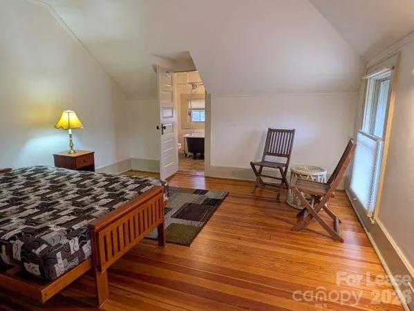 a living room with wooden floor and furniture
