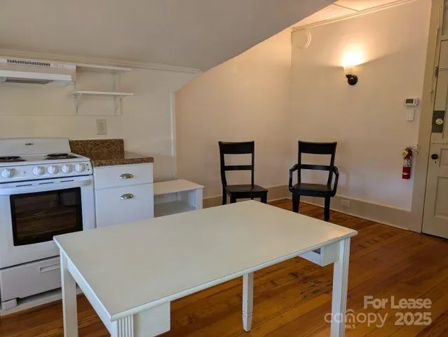 a view of kitchen with furniture and wooden floor
