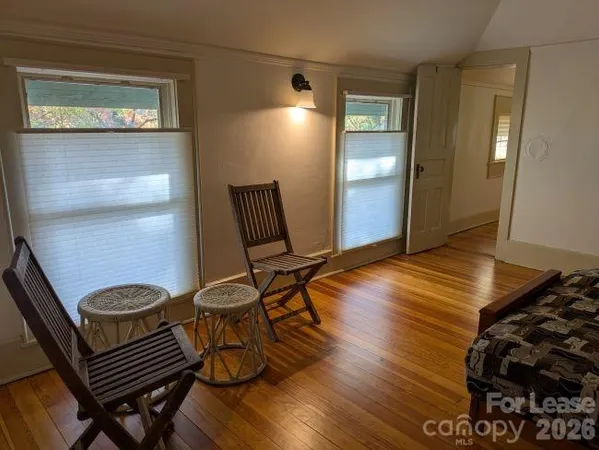 a view of a room with wooden floor and chair