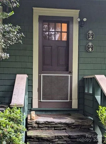 a couple of potted plants in front of door