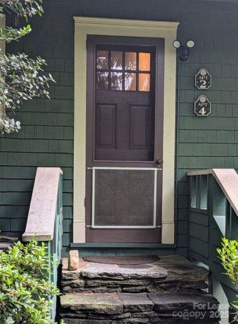 220 Melrose Circle, Unit 2 Tryon, NC 28782 - Photo 8 of 9 a couple of potted plants in front of door