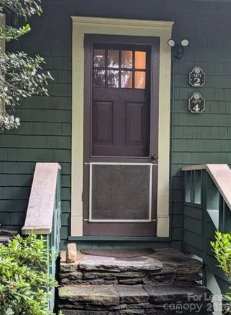 a couple of potted plants in front of door