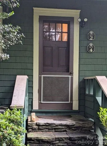 a couple of potted plants in front of door