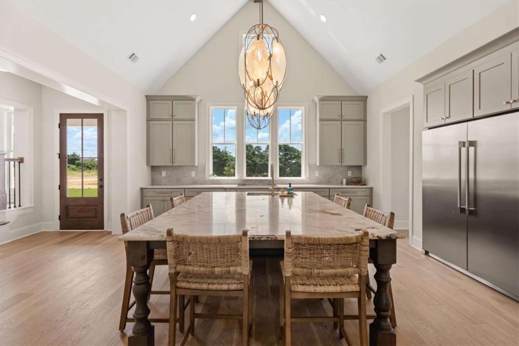 591 Welcome Road Roopville, GA 30170 - Photo 12 of 60 a dining room with furniture a rug and wooden floor