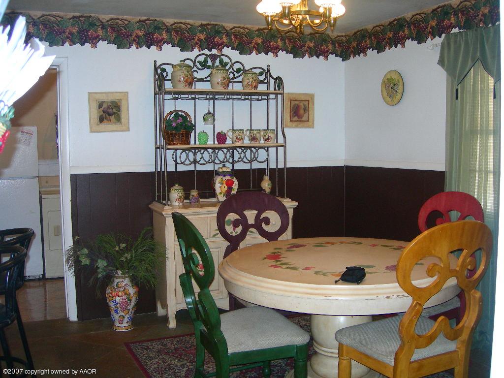 4004 Bowie Street Amarillo, TX 79110 - Photo 3 of 9 a view of a dining room with furniture and wooden floor