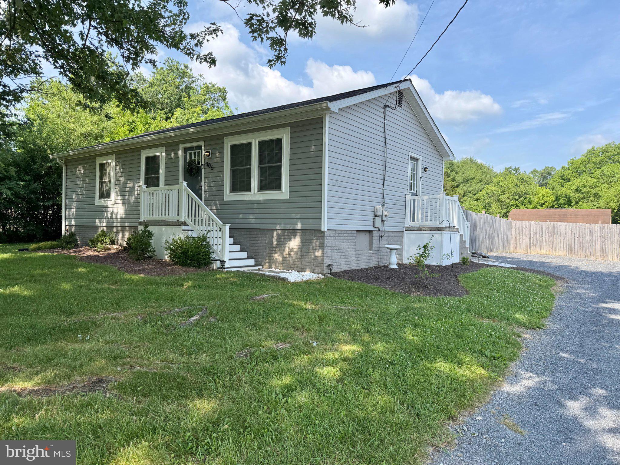 306 Fegan Road Bunker Hill, WV 25413 - Photo 2 of 2 Charming home with lush greenery.