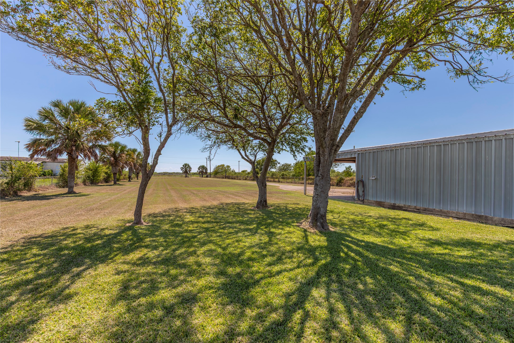 267 South Gulf Road Bay City, TX 77414 - Photo 3 of 26 a backyard of a house with lots of green space and fountain