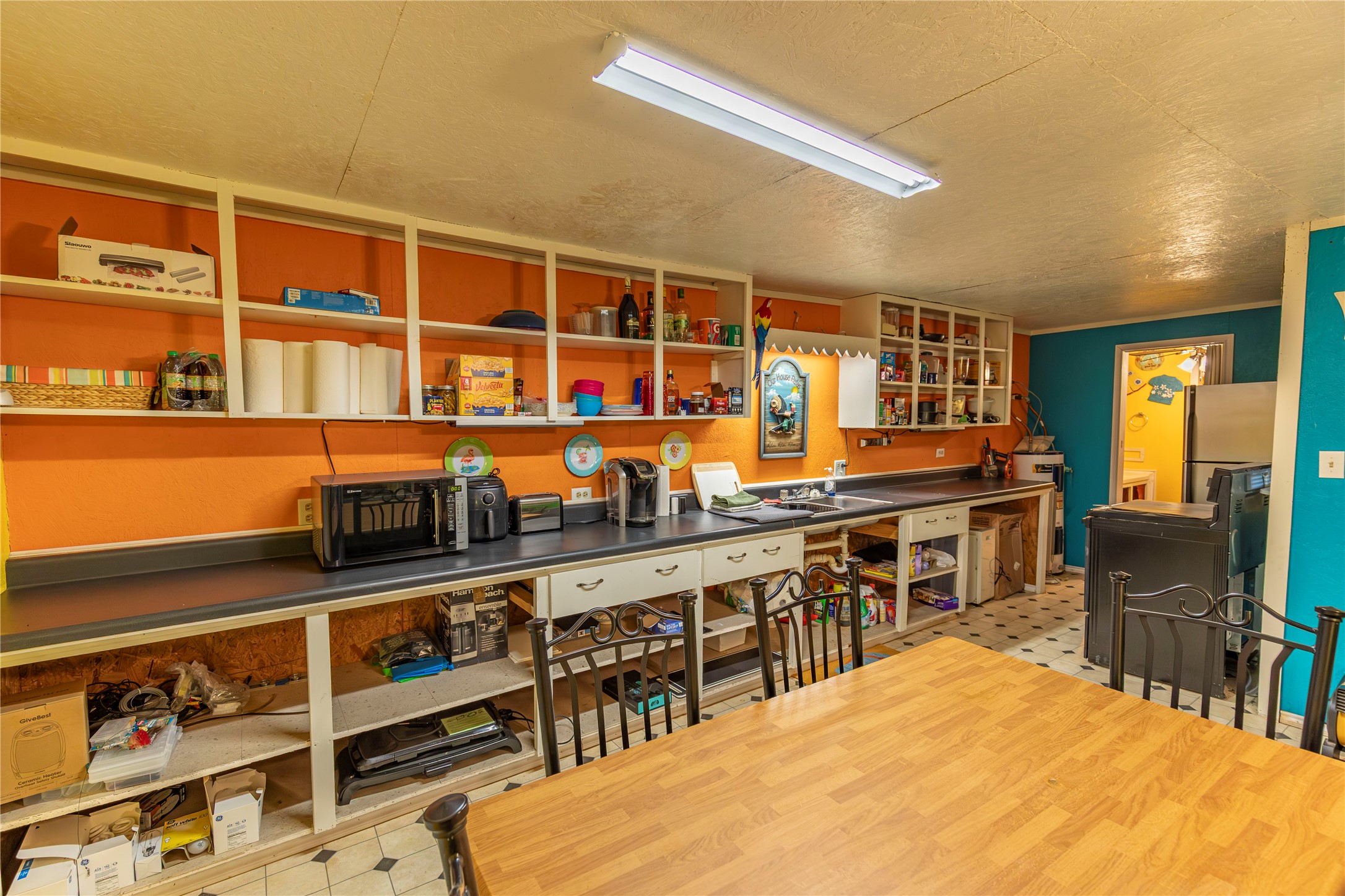 267 South Gulf Road Bay City, TX 77414 - Photo 9 of 26 a room with stainless steel appliances kitchen island granite countertop a table chairs in it and a large window