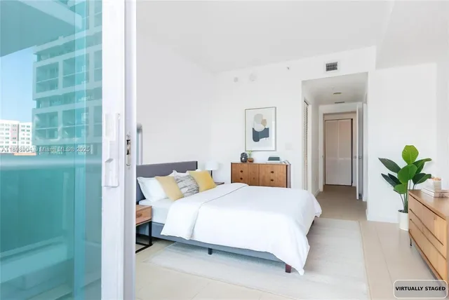 a bedroom with a bed and hallway